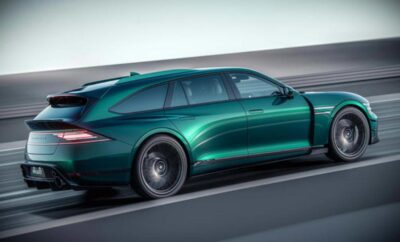 A sleek green electric station wagon driving on a highway.