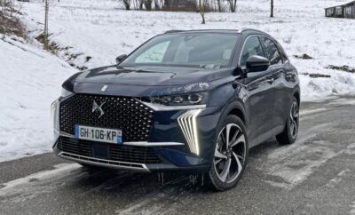 A sleek black DS 4 car parked on a snowy road.