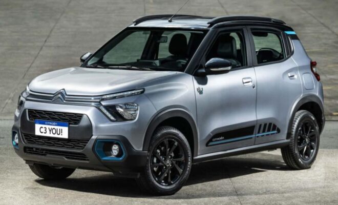 A modern silver compact SUV with black accents parked on a concrete surface.