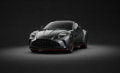 Sleek black sports car with aggressive front design on dark background.