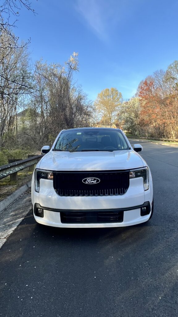 2025 Ford Maverick Lobo in Oxford White with black accents and 19-inch wheels, showing its lowered sporty stance