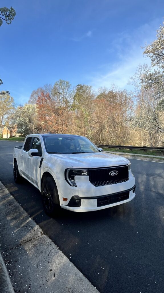 2025 Ford Maverick Lobo in Oxford White with black accents and 19-inch wheels, showing its lowered sporty stance