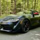 Dark gray 2026 Toyota GR Supra MkV Final Edition front three-quarter view with red mirror caps