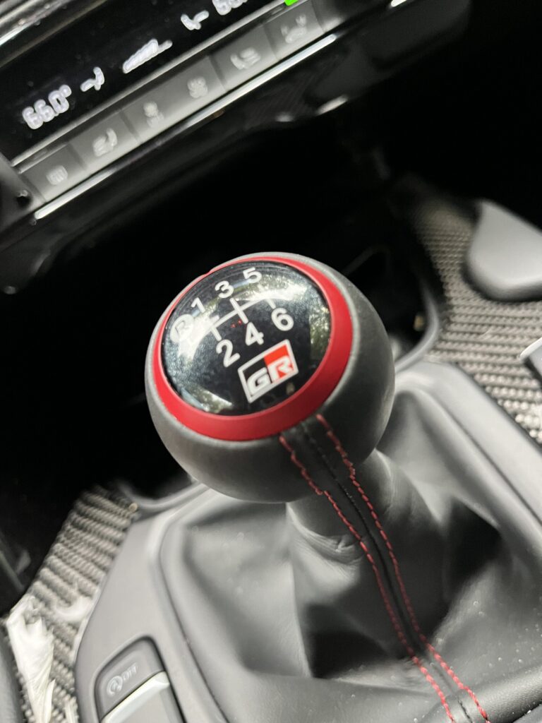 2026 Toyota GR Supra MkV Final Edition six-speed manual gear knob with red ring and stitching in a black cabin